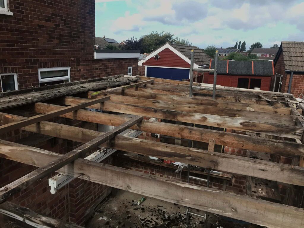 This is a photo of an old flat roof structure that has been stripped back to the timbers, and ready for replacement by EF Roofing Doncaster