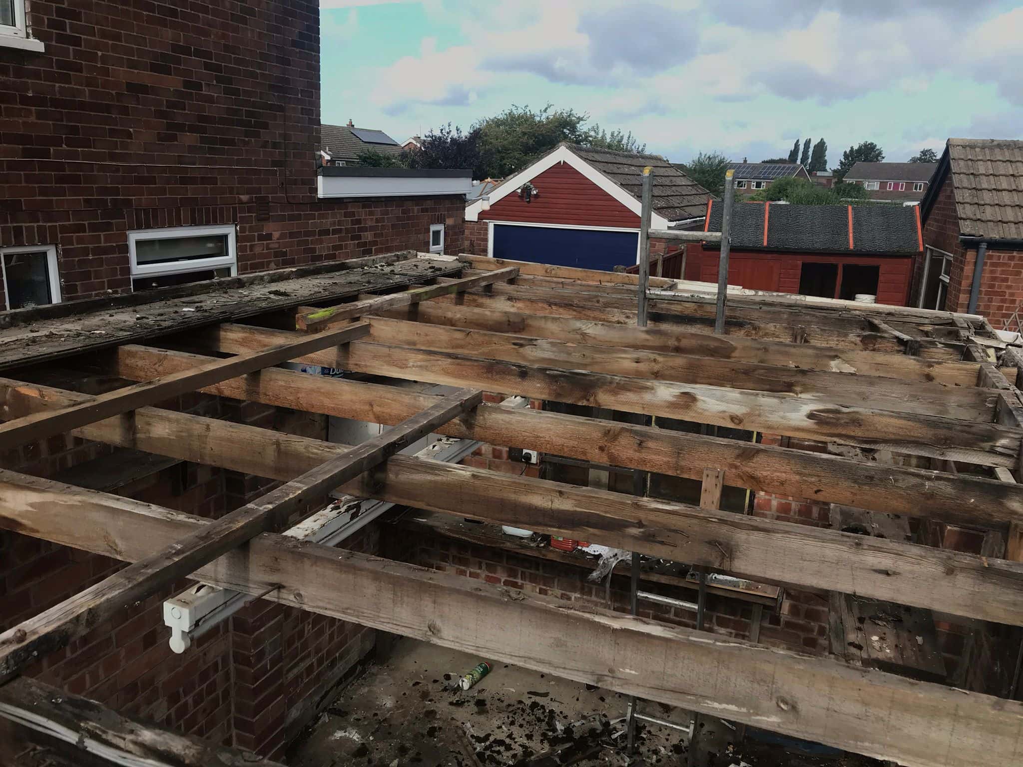 This is a photo of an old flat roof structure that has been stripped back to the timbers, and ready for replacement by EF Roofing Doncaster